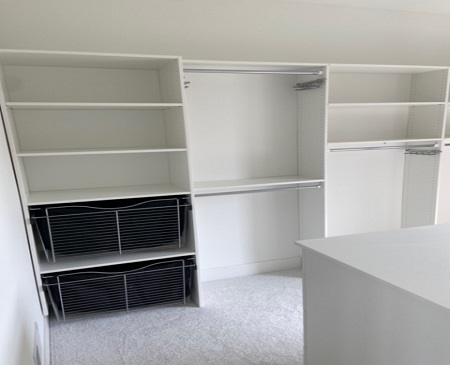 white shelving installation with hangers and ventilated wire baskets